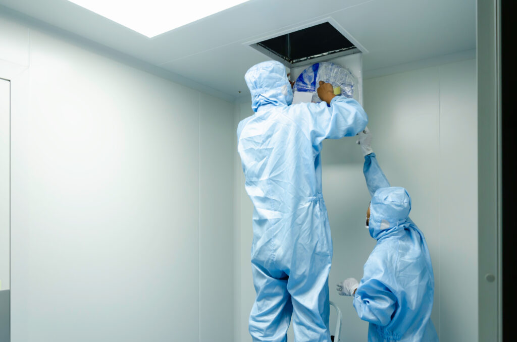 Technician checking a HEPA filter in a clean room